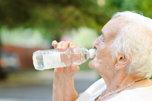 Elderly woman drinking water